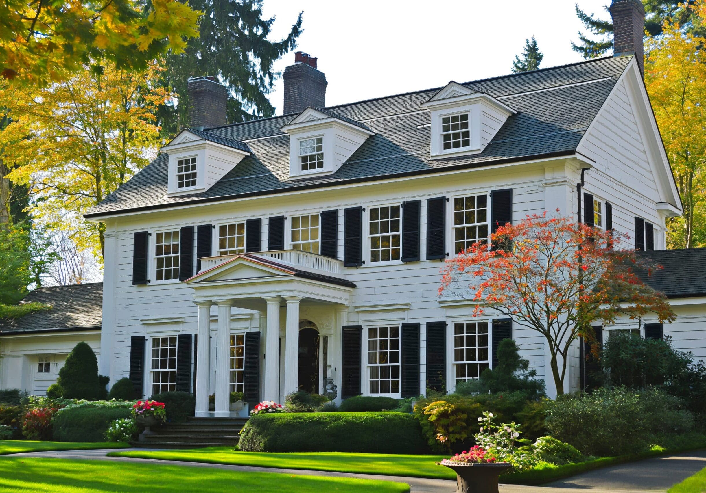 Classic colonial-style home in North Fulton, Georgia, with white siding, black shutters, and numerous grid windows.